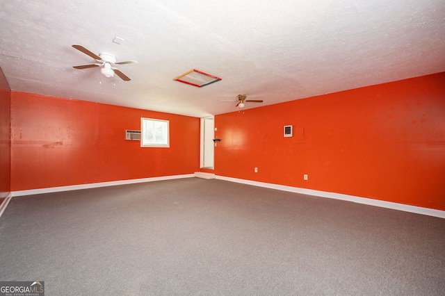 carpeted spare room featuring a textured ceiling and ceiling fan