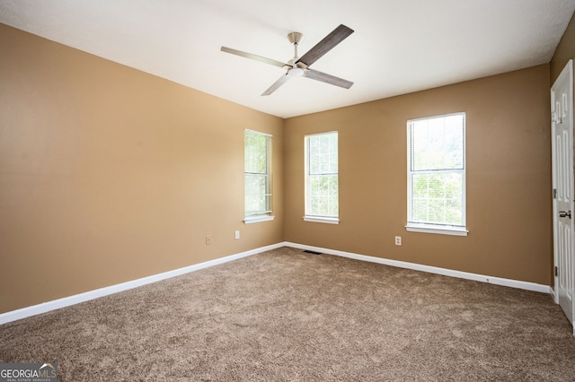 carpeted empty room featuring ceiling fan