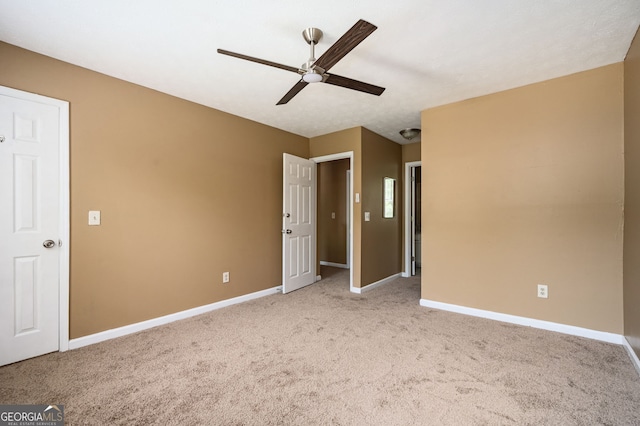 unfurnished bedroom with ceiling fan and light colored carpet