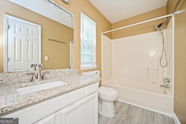 full bathroom with washtub / shower combination, vanity, and toilet