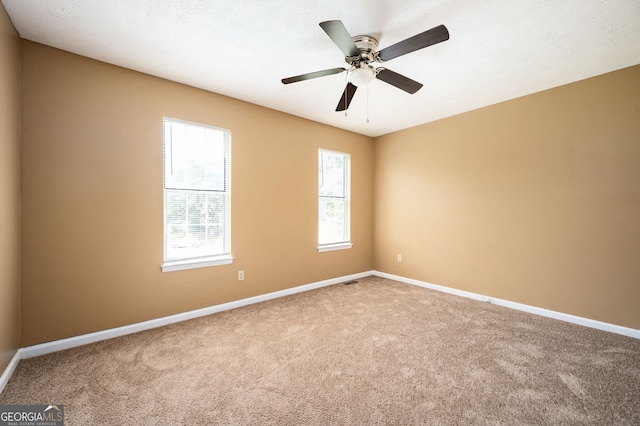 carpeted empty room featuring ceiling fan