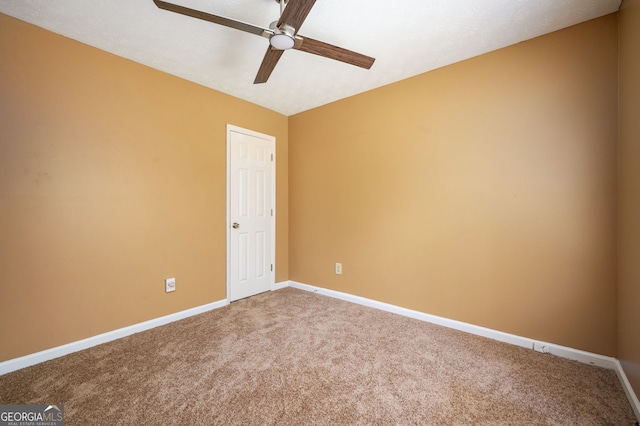 empty room featuring ceiling fan and carpet floors