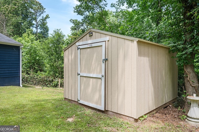 view of outdoor structure featuring a lawn