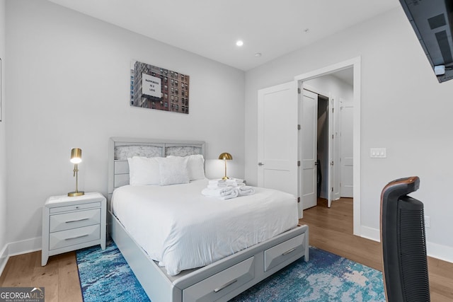 bedroom with hardwood / wood-style flooring