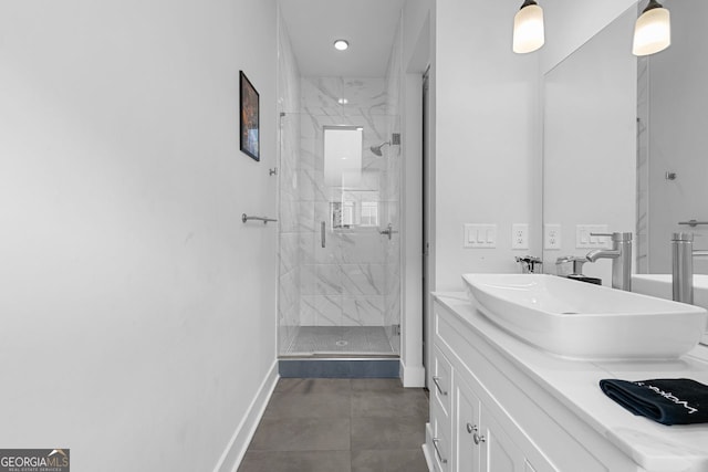 bathroom featuring a shower with door and vanity