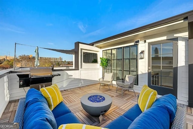 deck featuring an outdoor living space with a fire pit