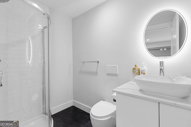 bathroom with toilet, vanity, and an enclosed shower