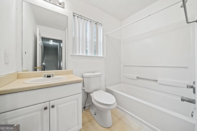 full bathroom featuring vanity, a textured ceiling, bathing tub / shower combination, and toilet