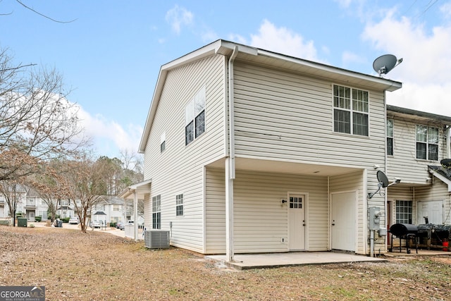 rear view of property featuring central AC and a patio area