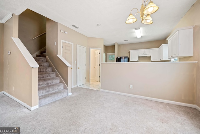 interior space with light colored carpet and a notable chandelier