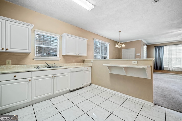 kitchen with pendant lighting, dishwasher, sink, white cabinets, and light colored carpet