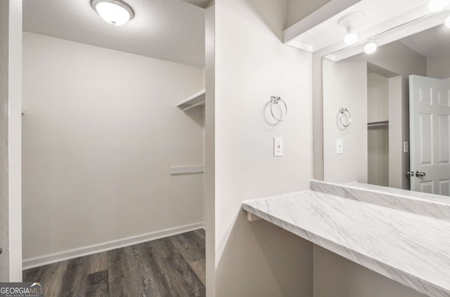 bathroom with wood-type flooring and a textured ceiling