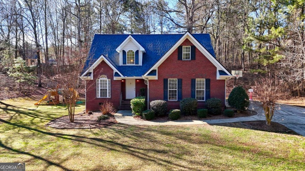 front of property featuring a playground and a front lawn