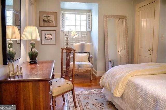 bedroom featuring baseboards and wood finished floors