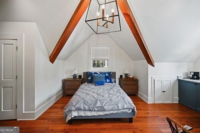 bedroom with lofted ceiling, an inviting chandelier, baseboards, and wood finished floors