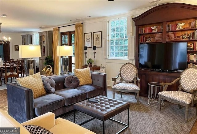 living room with crown molding and an inviting chandelier