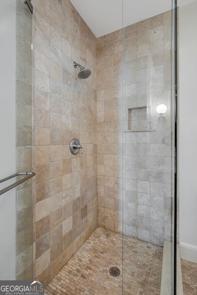 bathroom with a shower with shower door