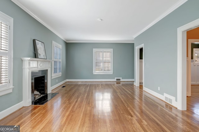 unfurnished living room featuring light wood-type flooring and ornamental molding