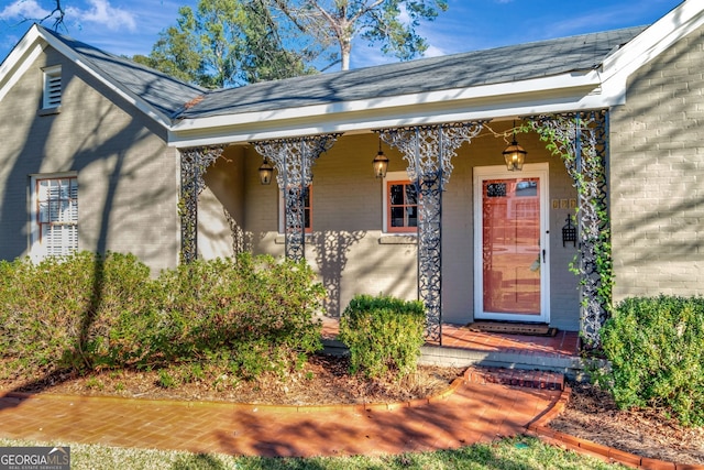 view of exterior entry with a porch