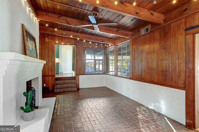 unfurnished sunroom with wooden ceiling, ceiling fan, and beamed ceiling