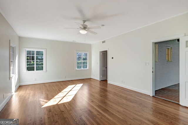 unfurnished room with ceiling fan, hardwood / wood-style floors, and ornamental molding