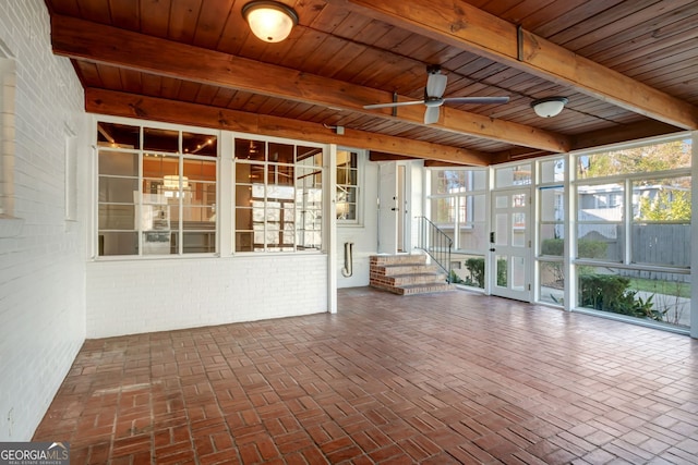 unfurnished sunroom with wood ceiling, ceiling fan, and beamed ceiling