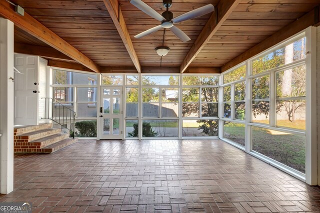 unfurnished sunroom with ceiling fan and beamed ceiling