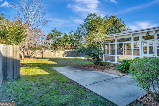 view of yard featuring a patio area and a sunroom