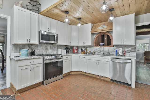 kitchen with sink, white cabinetry, pendant lighting, and appliances with stainless steel finishes