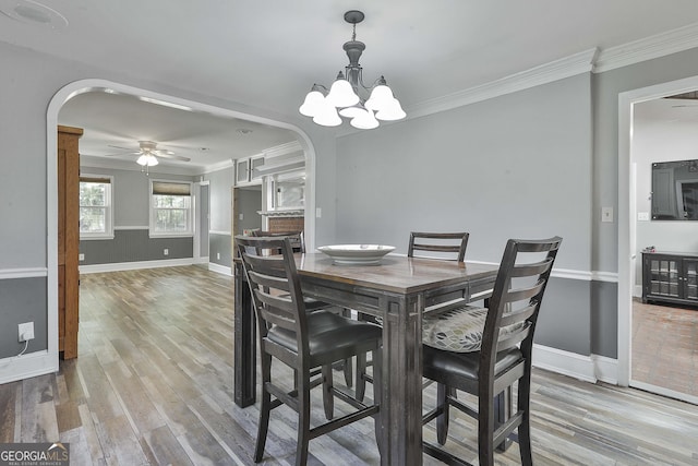 dining area featuring crown molding, ceiling fan with notable chandelier, and hardwood / wood-style flooring