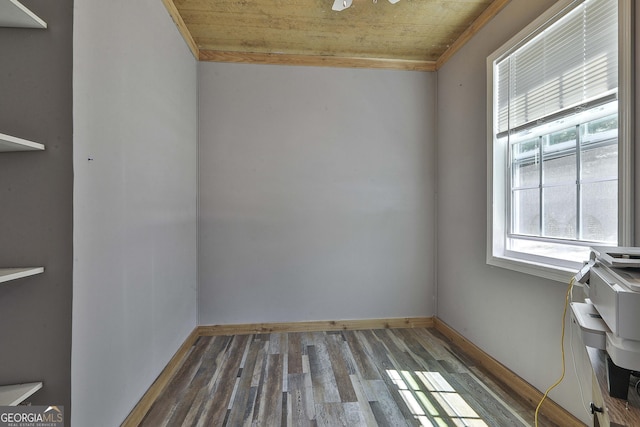 spare room with dark hardwood / wood-style flooring and wooden ceiling