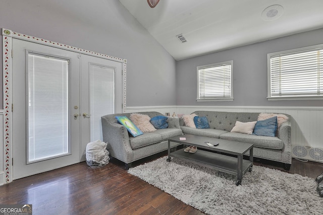 living room with lofted ceiling, dark wood-type flooring, and french doors