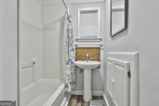 bathroom featuring shower / bath combo and hardwood / wood-style floors