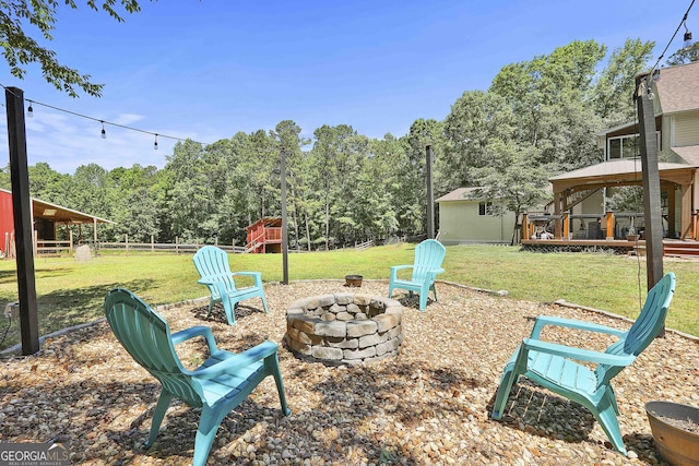 view of yard featuring a gazebo, an outdoor fire pit, a playground, and a wooden deck