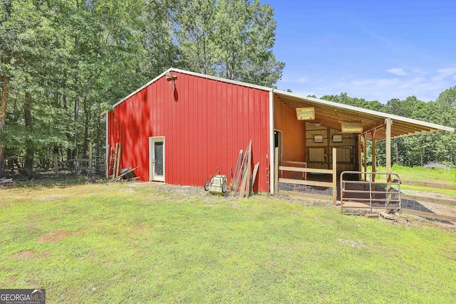 view of outbuilding featuring a lawn