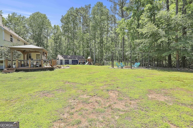 view of yard featuring a gazebo, an outdoor structure, and a wooden deck