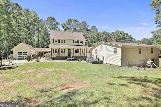 back of house featuring a yard, covered porch, and central AC unit