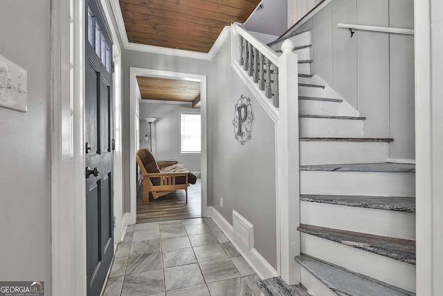 stairway featuring wooden ceiling and ornamental molding