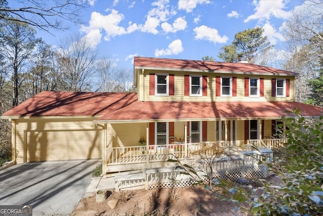 view of front of house with a porch and a garage