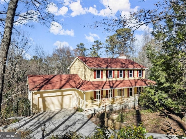 view of front of home featuring a porch and a garage