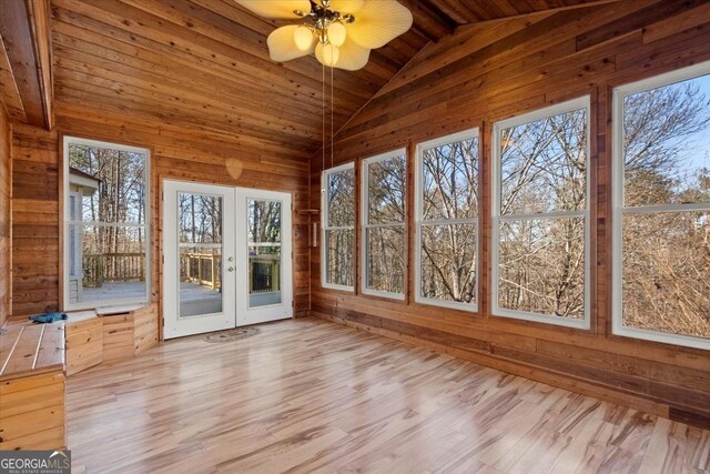 unfurnished sunroom featuring wood ceiling, french doors, a healthy amount of sunlight, and vaulted ceiling with beams