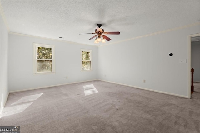 unfurnished room featuring crown molding, light carpet, ceiling fan, and a textured ceiling