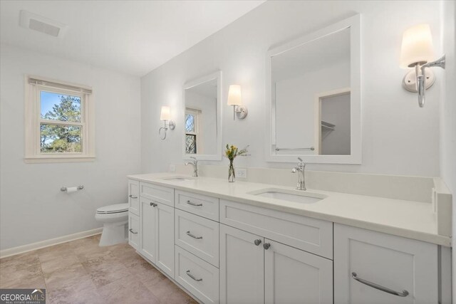 bathroom with toilet and vanity