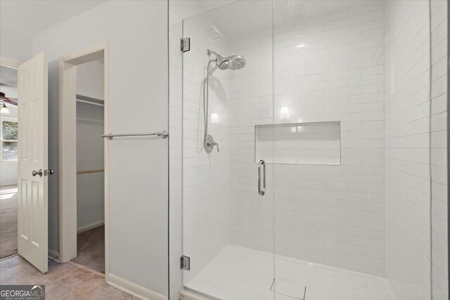 bathroom with ceiling fan and walk in shower