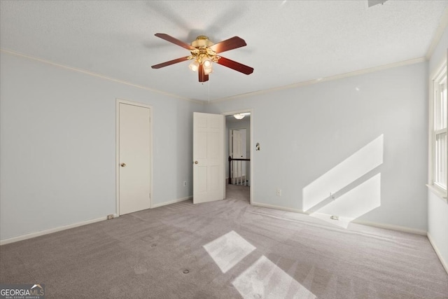 unfurnished bedroom with light carpet, a textured ceiling, ceiling fan, and ornamental molding