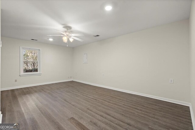 spare room with ceiling fan and dark hardwood / wood-style flooring