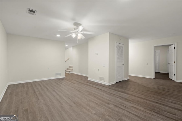 spare room with dark hardwood / wood-style floors and ceiling fan