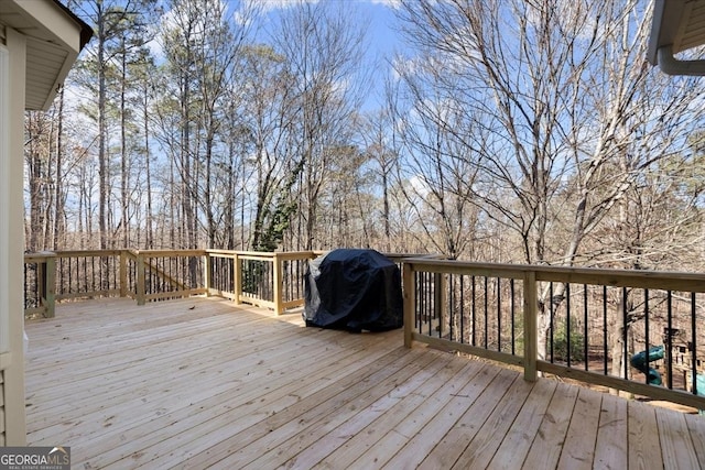 wooden deck with a grill