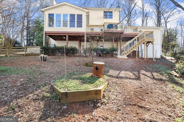 rear view of house featuring a wooden deck