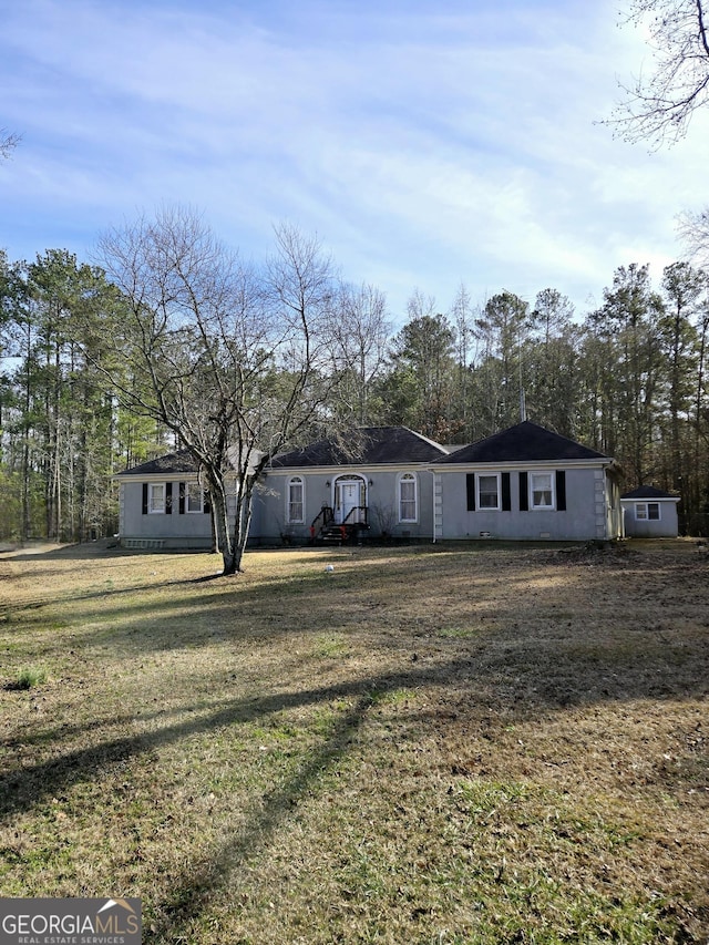 ranch-style house featuring a front lawn